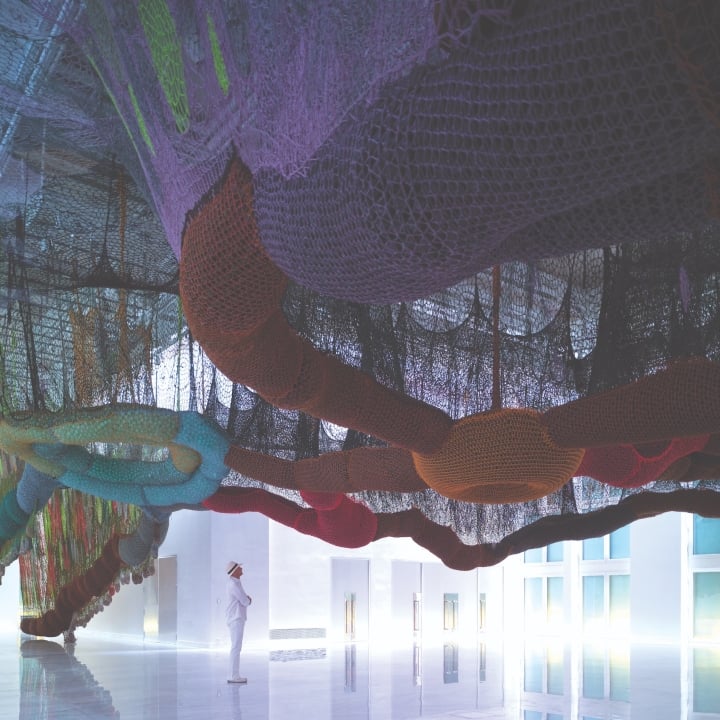 Alan Faena looking up at an art exhibit