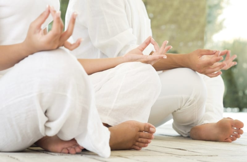 two people sitting in lotus position