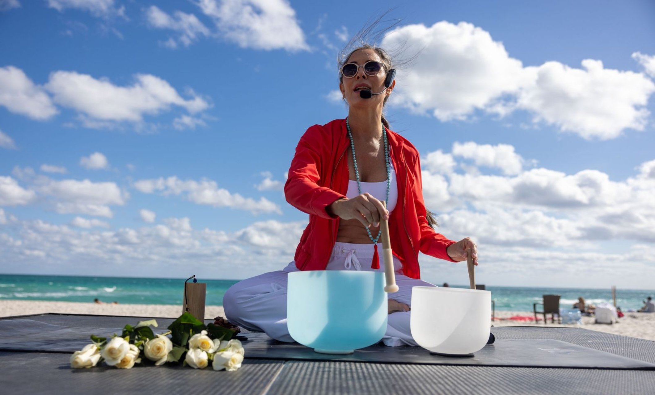 Agustina using sound bowls while leading Hypnotic Full Moon Flow and Meditation